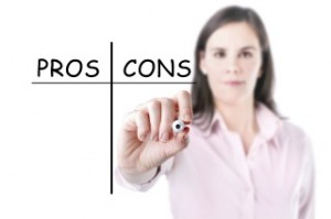 Young businesswoman writing pros and cons comparison concept.493247075